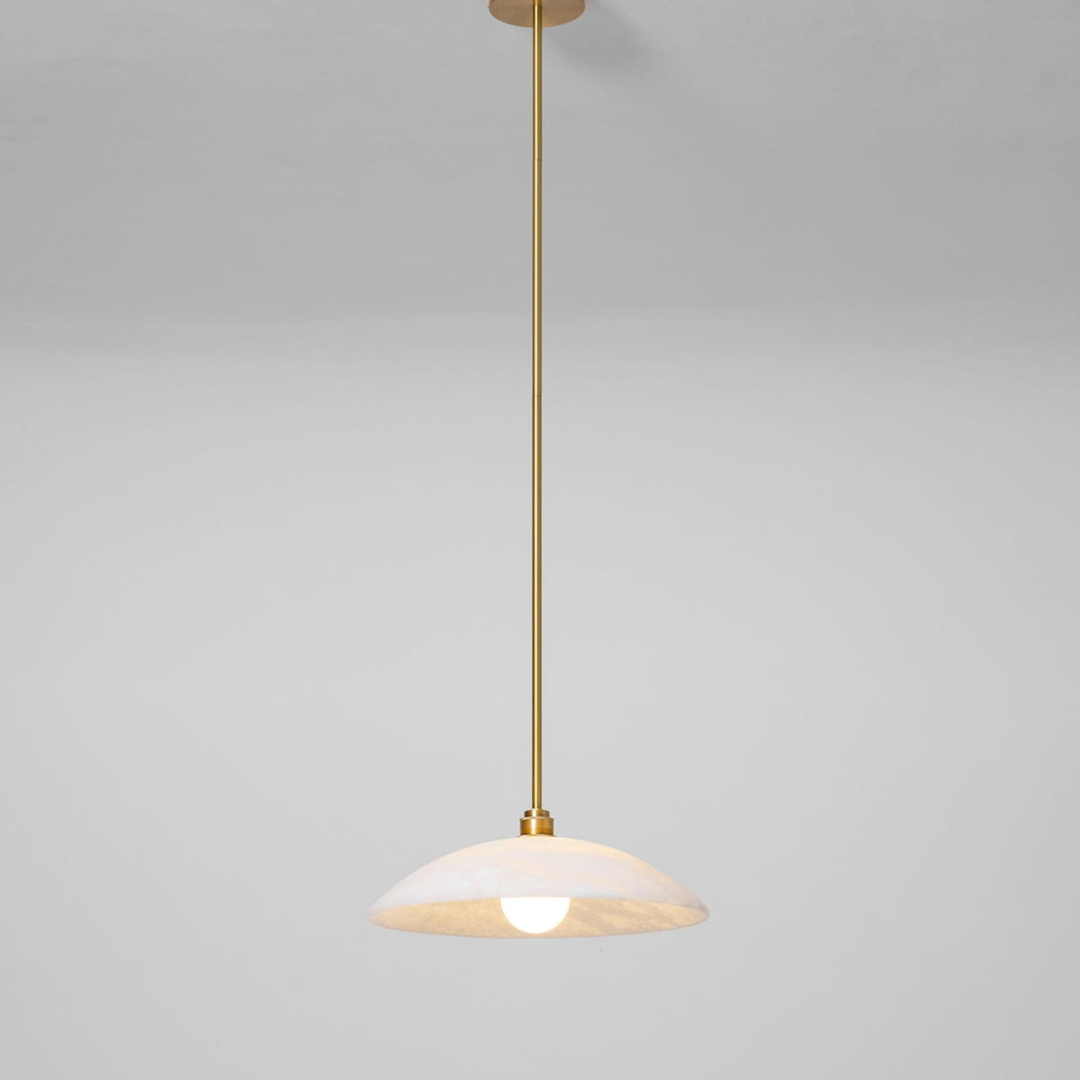Marble dome pendant on a metallic suspension rod