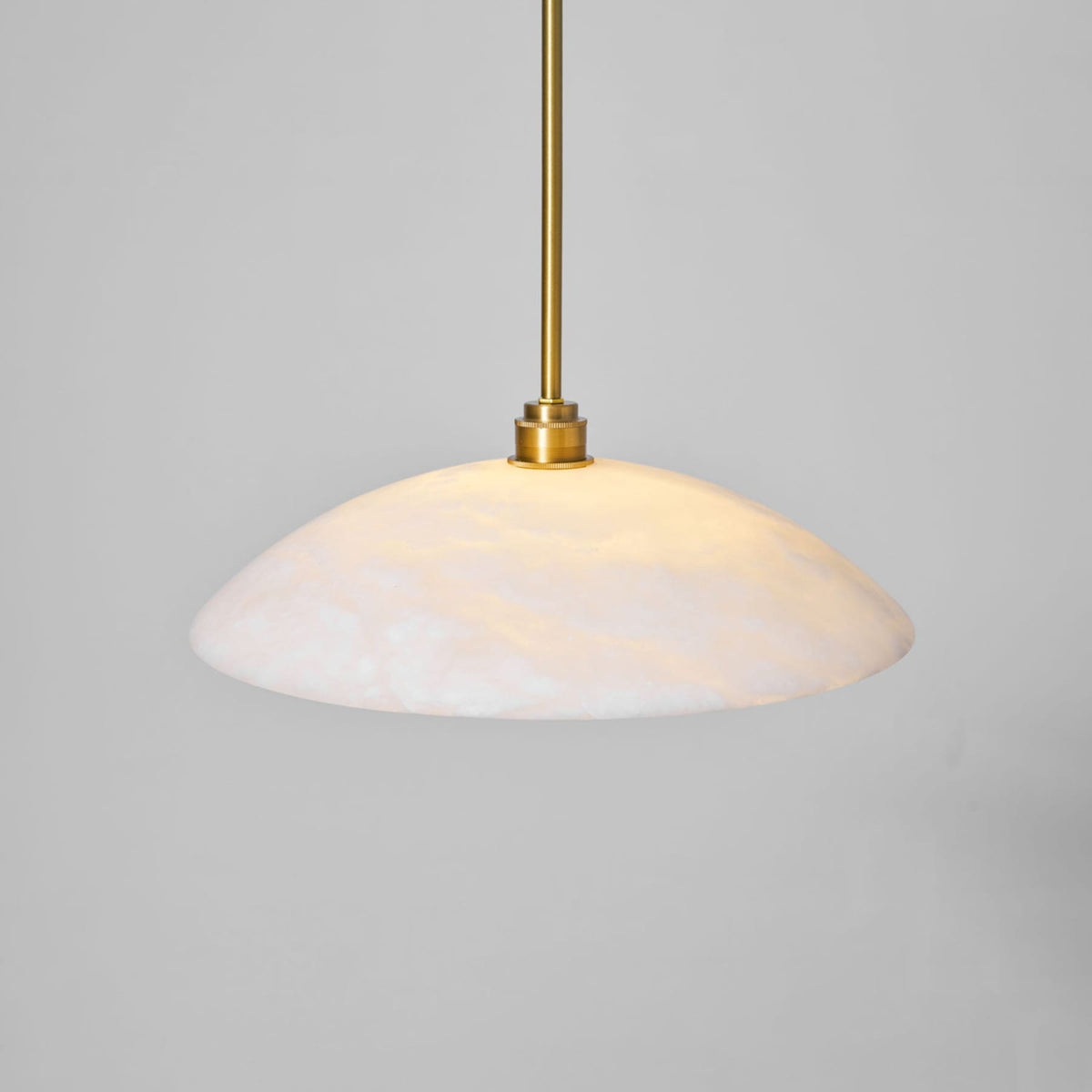 Close-up of illuminated marble shade and metallic fitting