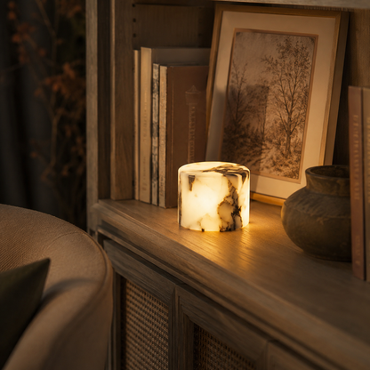 Illuminated marble lamp on a bookshelf