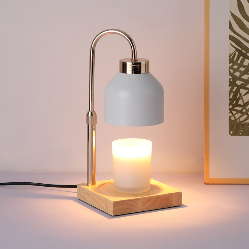 White candle warmer lamp with an arched brass-style arm and matte shade