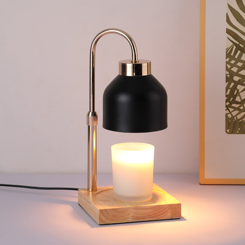Black candle warmer lamp warming a jar candle beneath its matte shade
