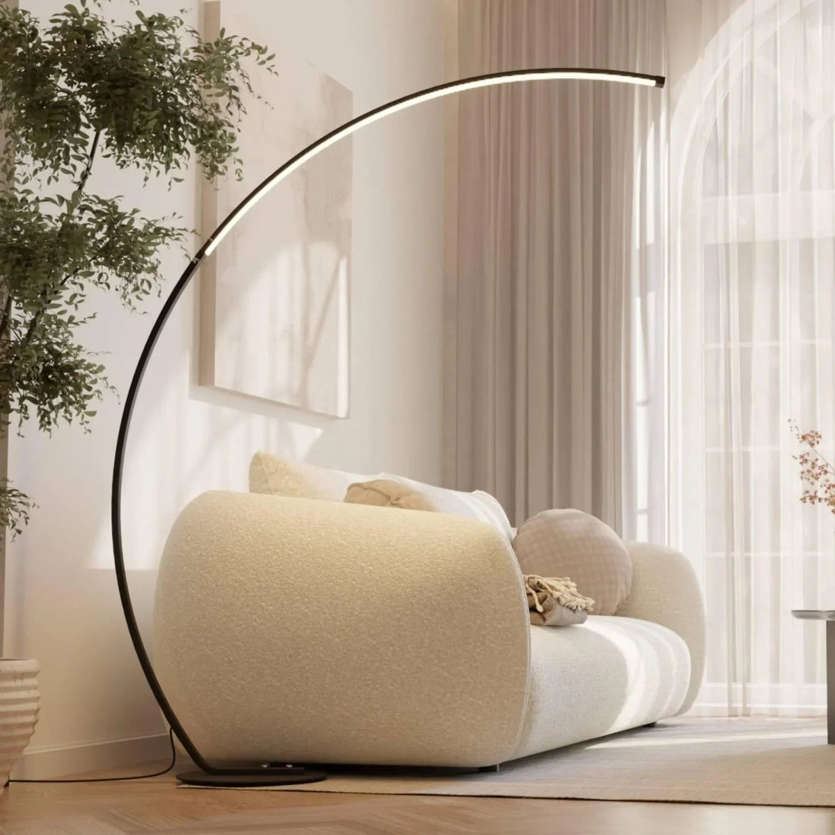 Black arc LED floor lamp extending over a sofa