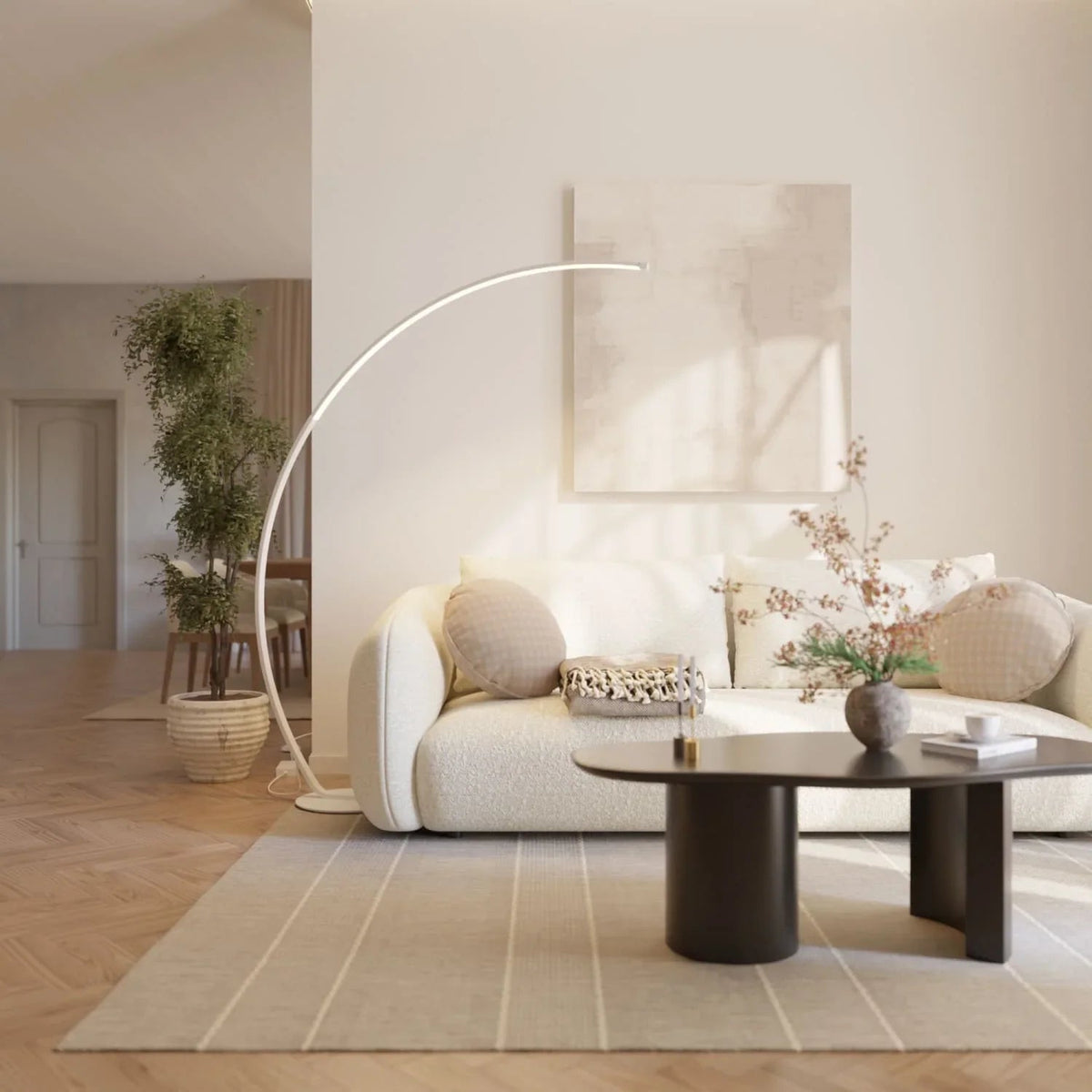 White arc floor lamp beside a living room sofa
