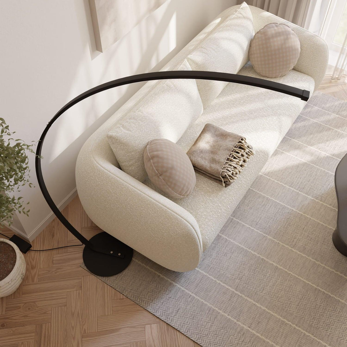 Black arc lamp and circular base viewed from above
