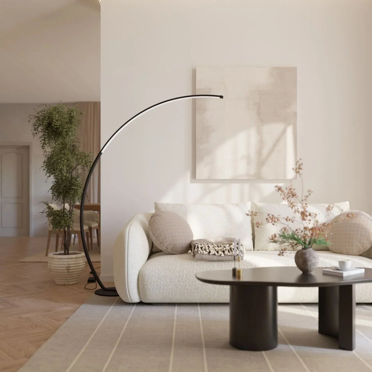 Black arc floor lamp beside a living room sofa