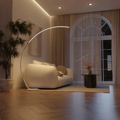 White arc floor lamp illuminating a living room at night