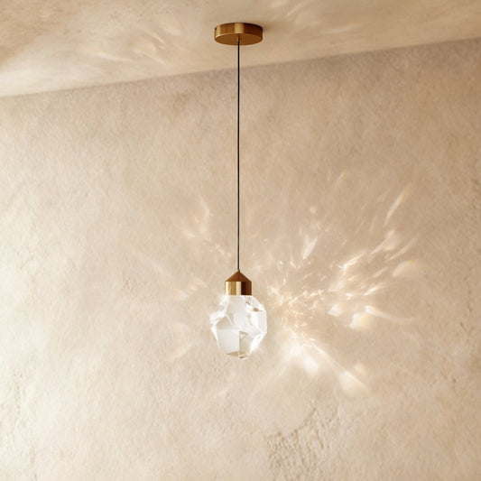 Mini faceted crystal pendant casting reflections on a wall