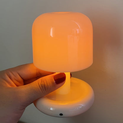 Milky white mini mushroom table lamp held in a hand