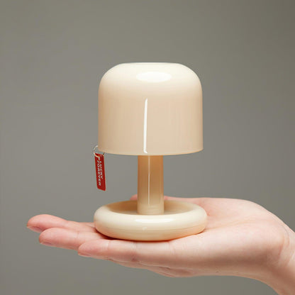 Milky white mini mushroom table lamp held in a hand