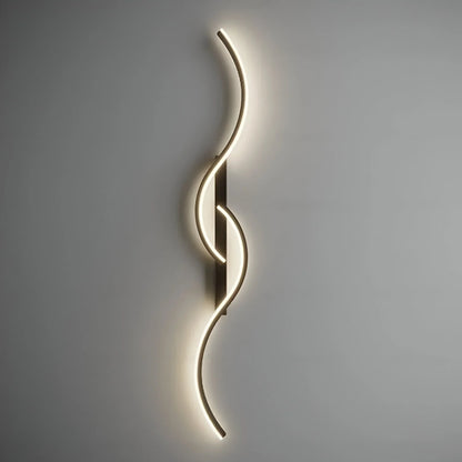 A minimalist curved LED wall light with a sleek, wave-like design mounted on a neutral grey wall, emitting a soft, warm glow for modern indoor lighting.