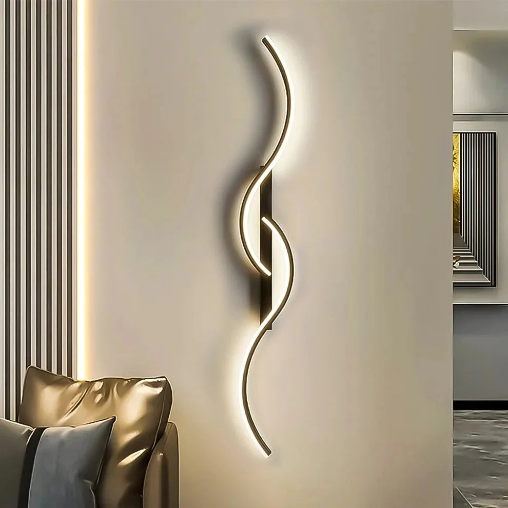 Minimalist black curved LED wall light mounted on a neutral interior wall, featuring a sleek, modern design that emits a soft, warm ambient glow.