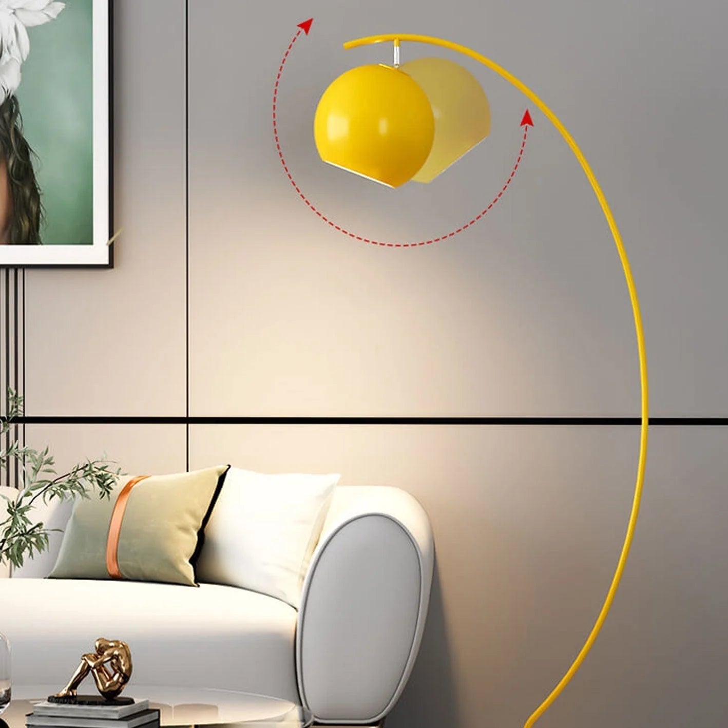 Yellow minimalist LED arc floor lamp with an adjustable spherical head, casting a warm glow next to a white sofa in a modern living room.