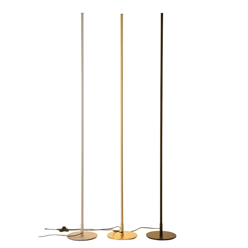 Three minimalist LED floor lamps in silver, gold and black finishes, featuring slim vertical poles and circular bases on a plain white background.