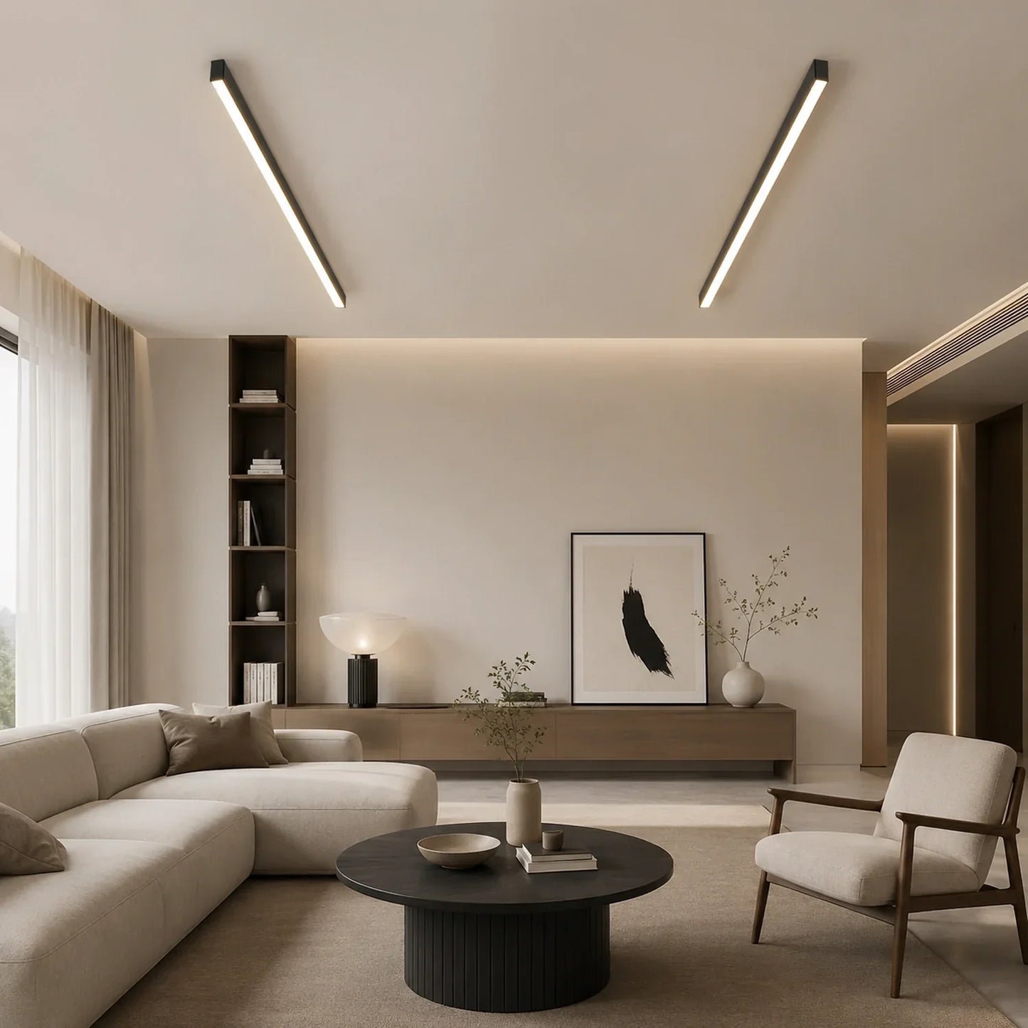 Two minimalist linear LED ceiling lights installed in a modern living room with a neutral colour palette, cream sofa, and dark wooden coffee table.