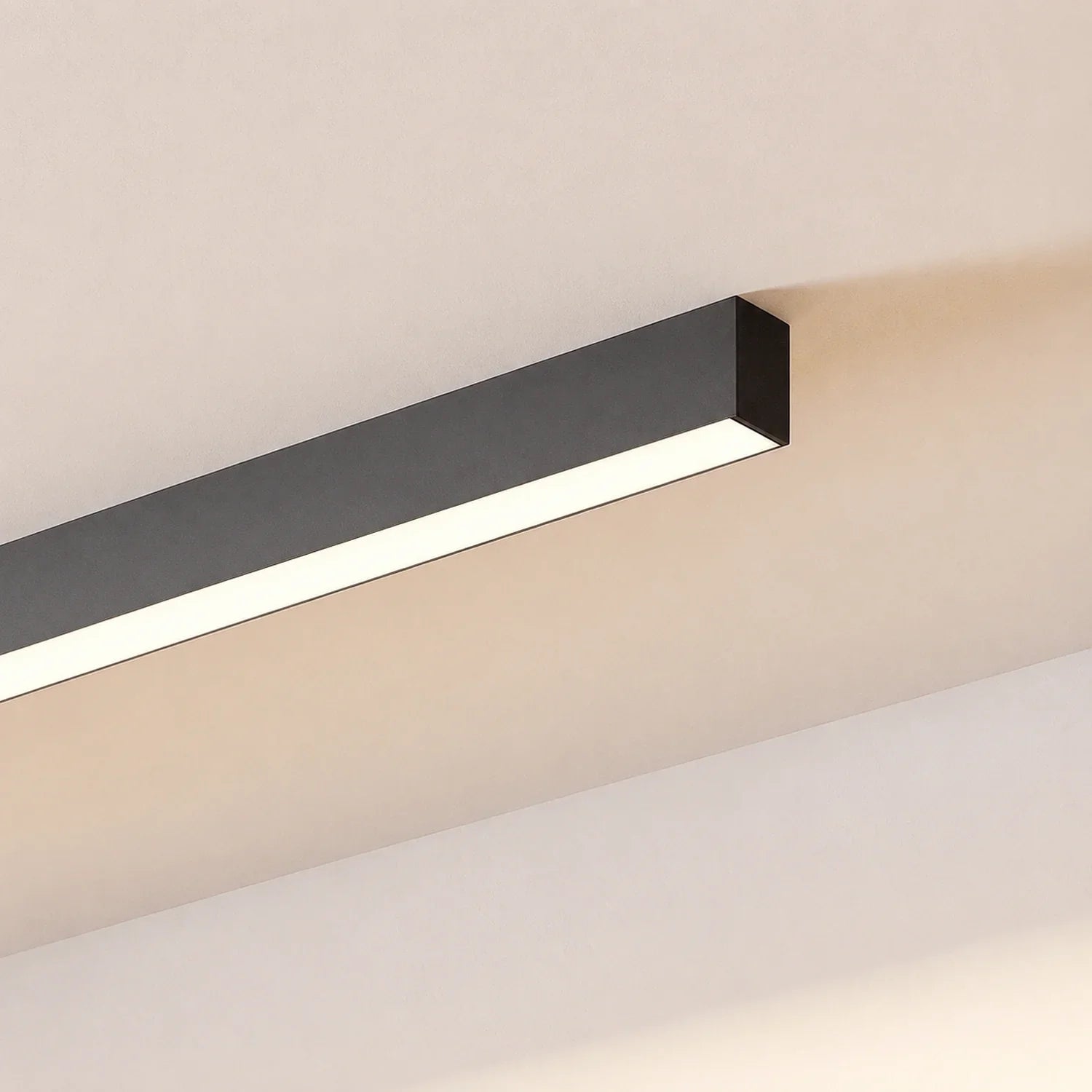 Minimalist linear LED ceiling light in a sleek black finish, surface-mounted to provide modern interior lighting with a clean, contemporary aesthetic.