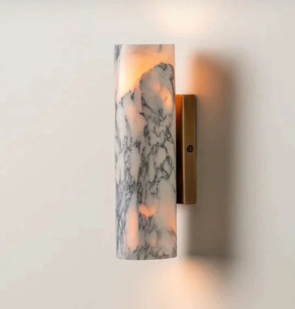 Minimalist rectangular wall lamp featuring a white marble shade with grey veining and a warm brass base, mounted on a plain wall for modern home lighting.