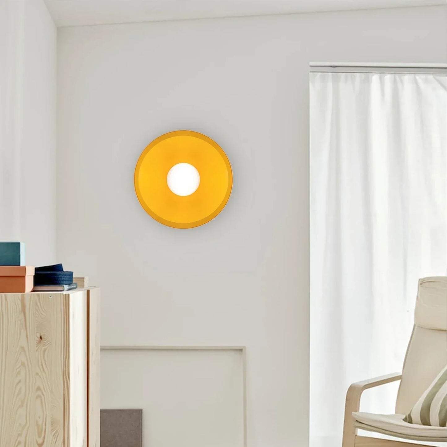 Modern Bauhaus style flush mount ceiling light with a circular yellow frame and central white glass globe, mounted on a plain white interior wall.
