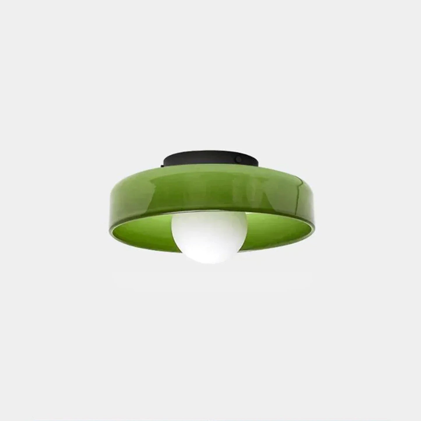 Modern Bauhaus style flush mount ceiling light featuring a glossy green glass shade with a central white bulb and a black iron base against a white backgro