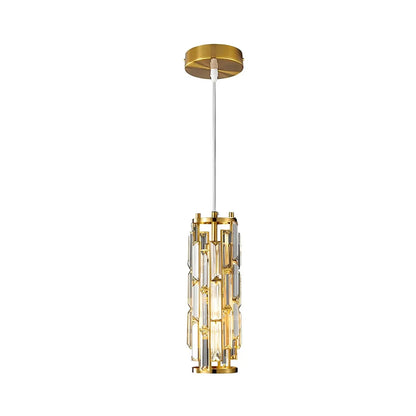 Modern crystal pendant light featuring a cylindrical gold frame with clear crystal prisms, suspended by an adjustable white cord from a gold