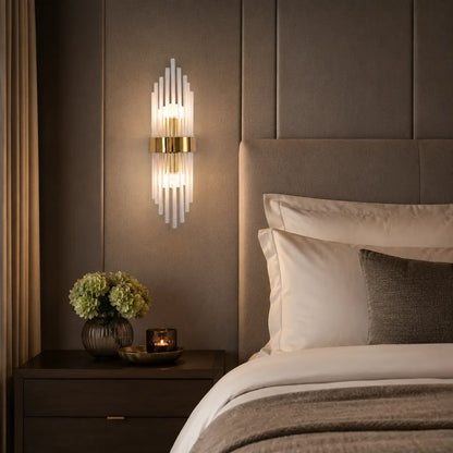Modern 35cm gold crystal wall light mounted above a bedside table in a bedroom, featuring a sleek metal frame and elegant up and down lighting design.