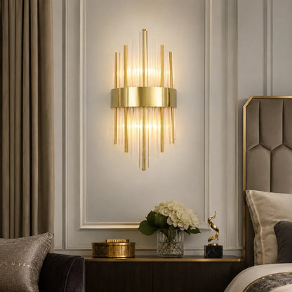 Modern 45cm gold wall light featuring vertical crystal rods and a central metal band, mounted on a panelled bedroom wall to provide warm ambient lighting.