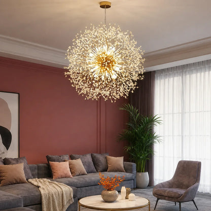 A modern dandelion LED pendant light with a gold finish hanging in a stylish living room with a grey sofa, armchair and terracotta-coloured walls.