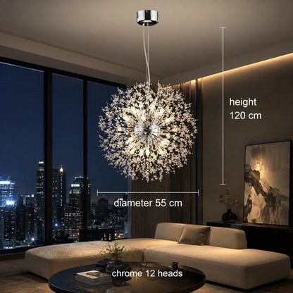 Modern 55cm chrome dandelion LED pendant light with 12 heads, suspended in a contemporary living room with city skyline views at night.