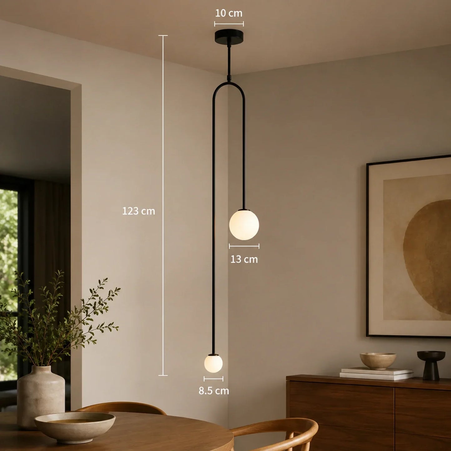 Modern black double globe pendant light with dimensions shown, featuring two white spherical shades suspended in a minimalist dining room interior.