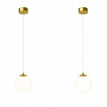 Two modern pendant lights featuring spherical white glass globes suspended from circular brass ceiling mounts against a plain white background.