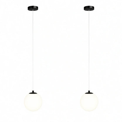 Two modern pendant lights featuring spherical white glass globes suspended from black ceiling mounts on thin white cables against a plain background.