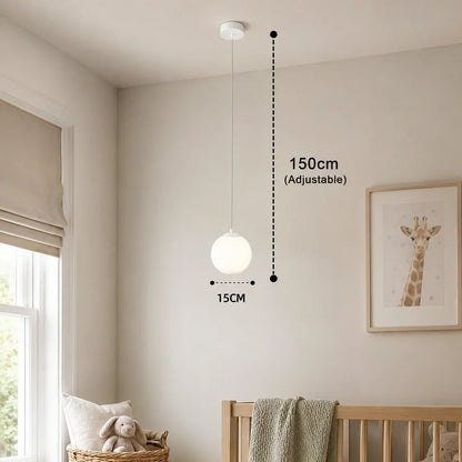 Modern white glass globe pendant light with an adjustable 150cm drop and 15cm diameter, shown installed in a neutral nursery setting.