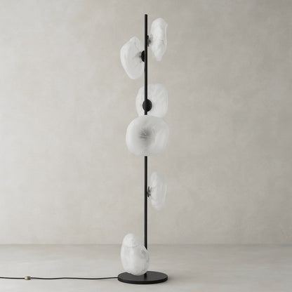 Modern floor lamp with a slim black metal stand and five organic, transparent glass shades arranged vertically, perfect for living room lighting.