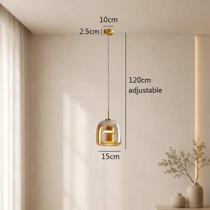 Modern glass pendant light with a gold finish, featuring a 15cm shade and an adjustable 120cm cable, displayed with technical dimensions in a room.
