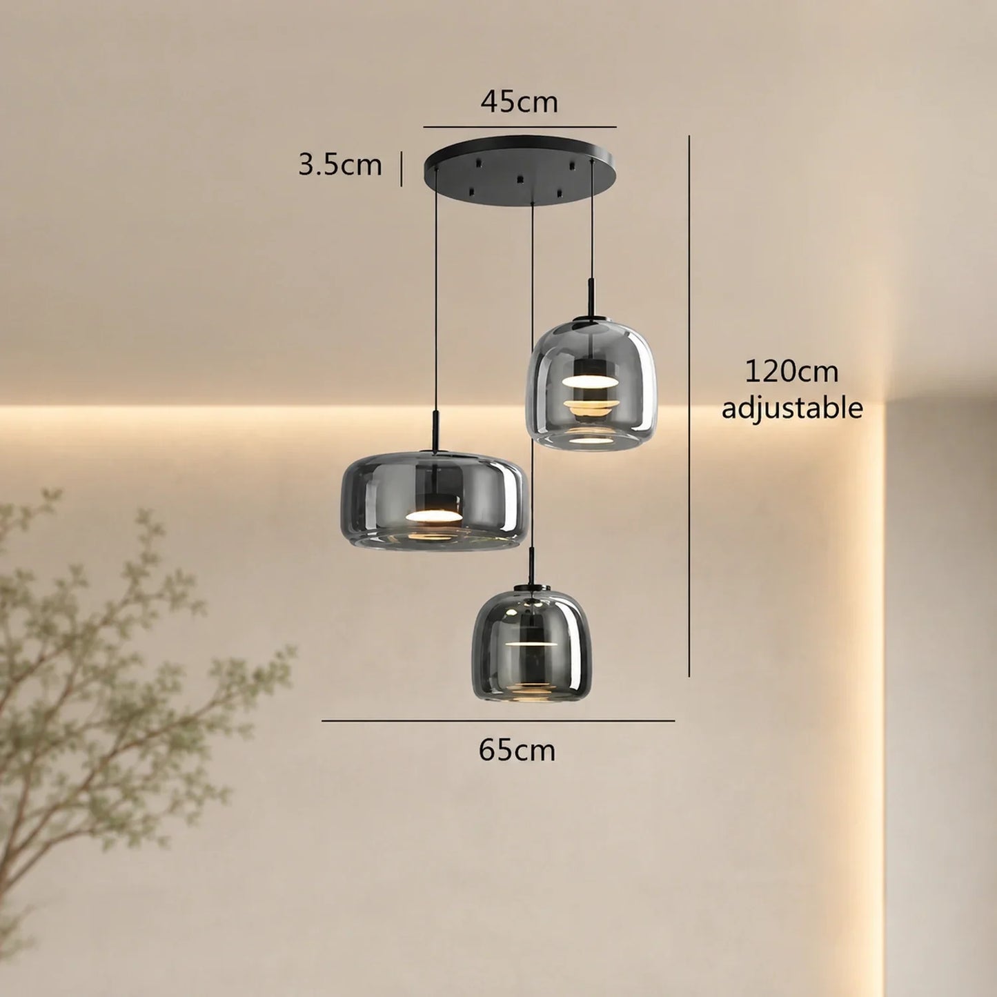 Modern round triple-head pendant light in smoky grey glass with dimensions shown, featuring three adjustable hanging lights on a black ceiling canopy.