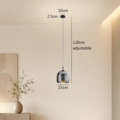 Modern single-head pendant light with a 15 cm smoky grey glass shade and adjustable 120 cm cable, displayed with technical dimensions in a room.