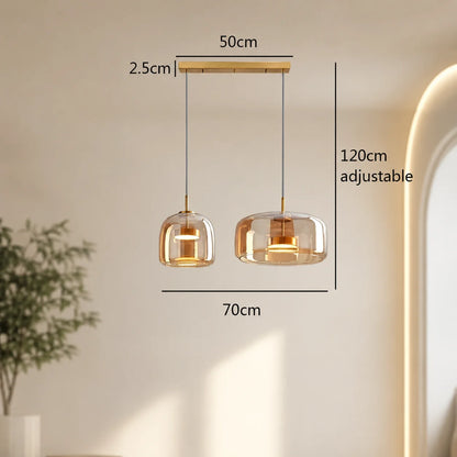 Modern double head amber glass pendant light with adjustable 120cm cables, featuring 26cm and 33cm shades on a 50cm ceiling bar for interior lighting.