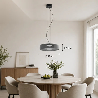Modern gray glass pendant light with integrated LED, 42cm diameter, suspended above a round dining table in a contemporary interior setting.