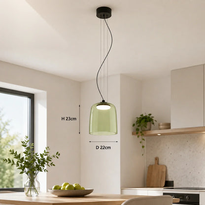 Modern green glass pendant light with integrated LED, 22cm diameter, suspended above a dining table in a contemporary kitchen interior setting.