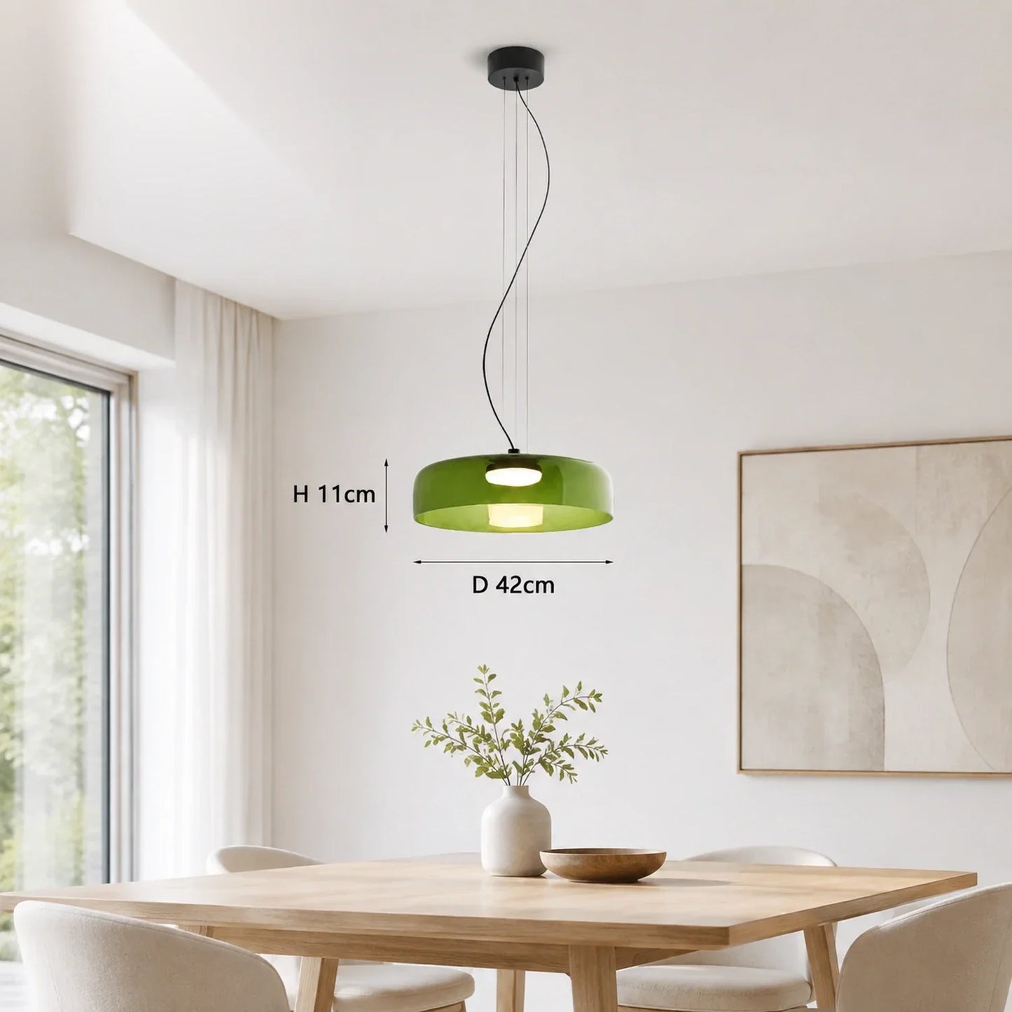 Modern green glass pendant light with integrated LED, 42cm diameter, suspended above a wooden dining table in a bright, contemporary interior setting.
