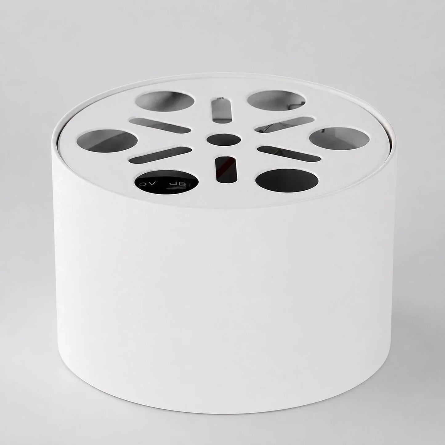 White cylindrical surface-mounted aluminium LED ceiling light, showing the top mounting plate with circular and slotted ventilation cutouts.