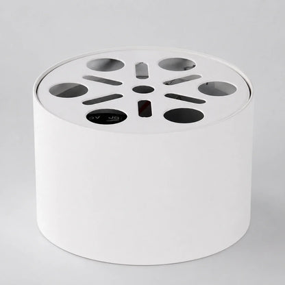 White cylindrical surface-mounted aluminium LED ceiling light, showing the top mounting plate with circular and slotted ventilation cutouts.