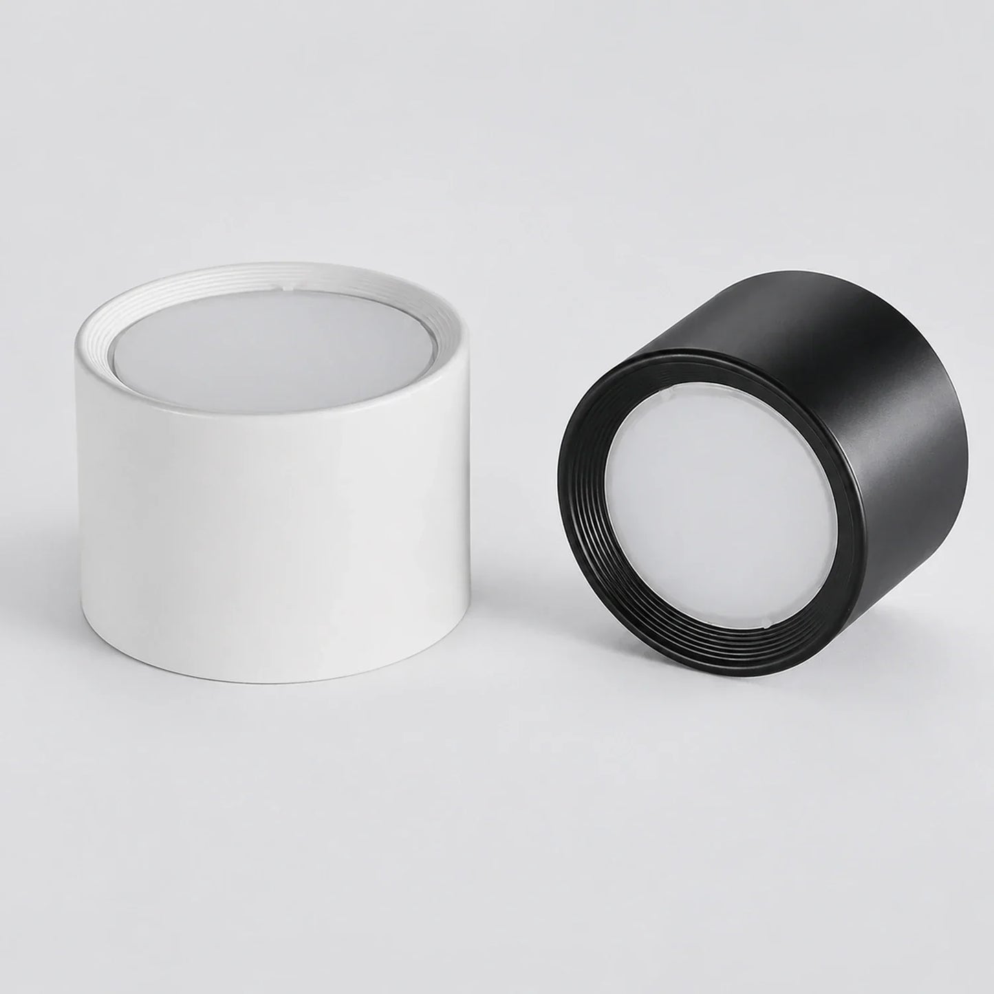 Modern LED ceiling lights in white and black. These minimalist, surface-mounted aluminium downlights are ideal for contemporary indoor lighting.