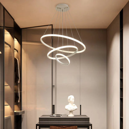 Modern white three-ring LED ceiling light suspended in a stylish dressing room, featuring adjustable circular tiers for contemporary interior lighting.
