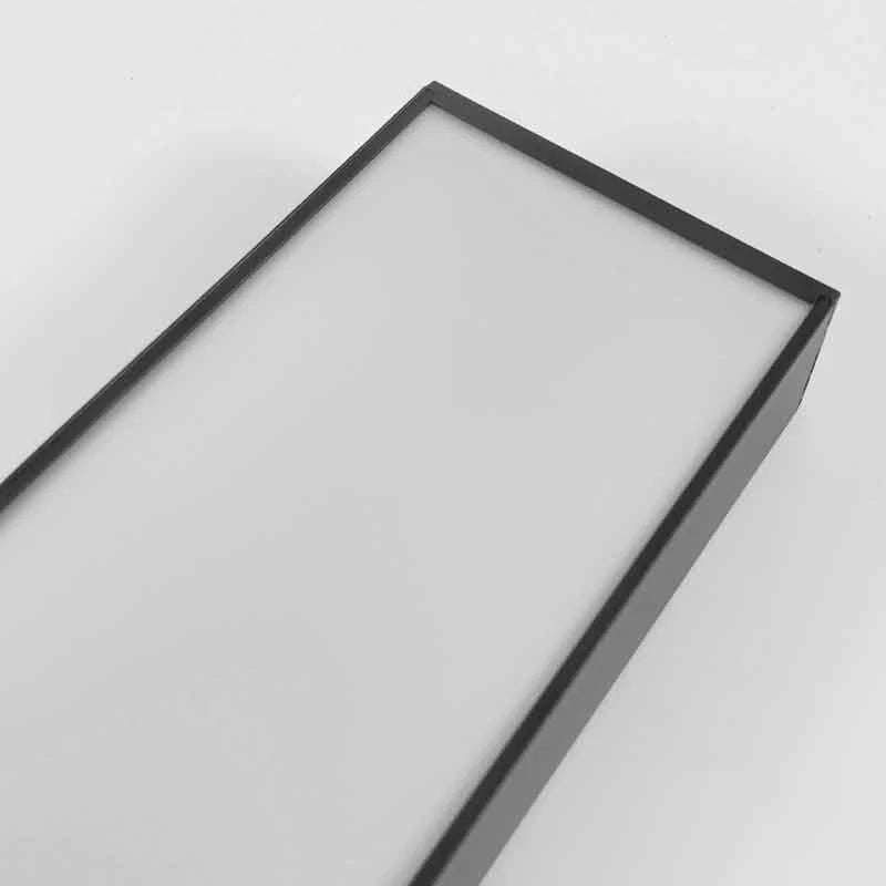 Close-up view of a modern black linear LED pendant light featuring a clean rectangular frame and a frosted white diffuser panel for commercial spaces.