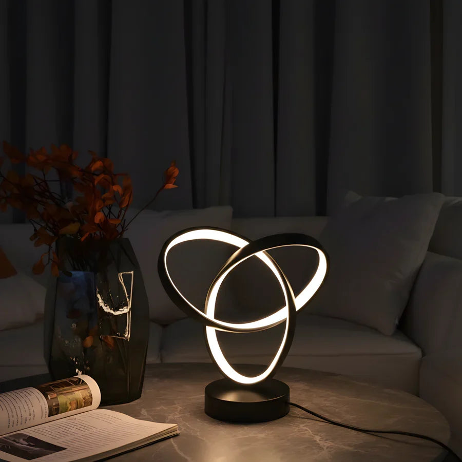 Black three-ring LED desk lamp with warm light