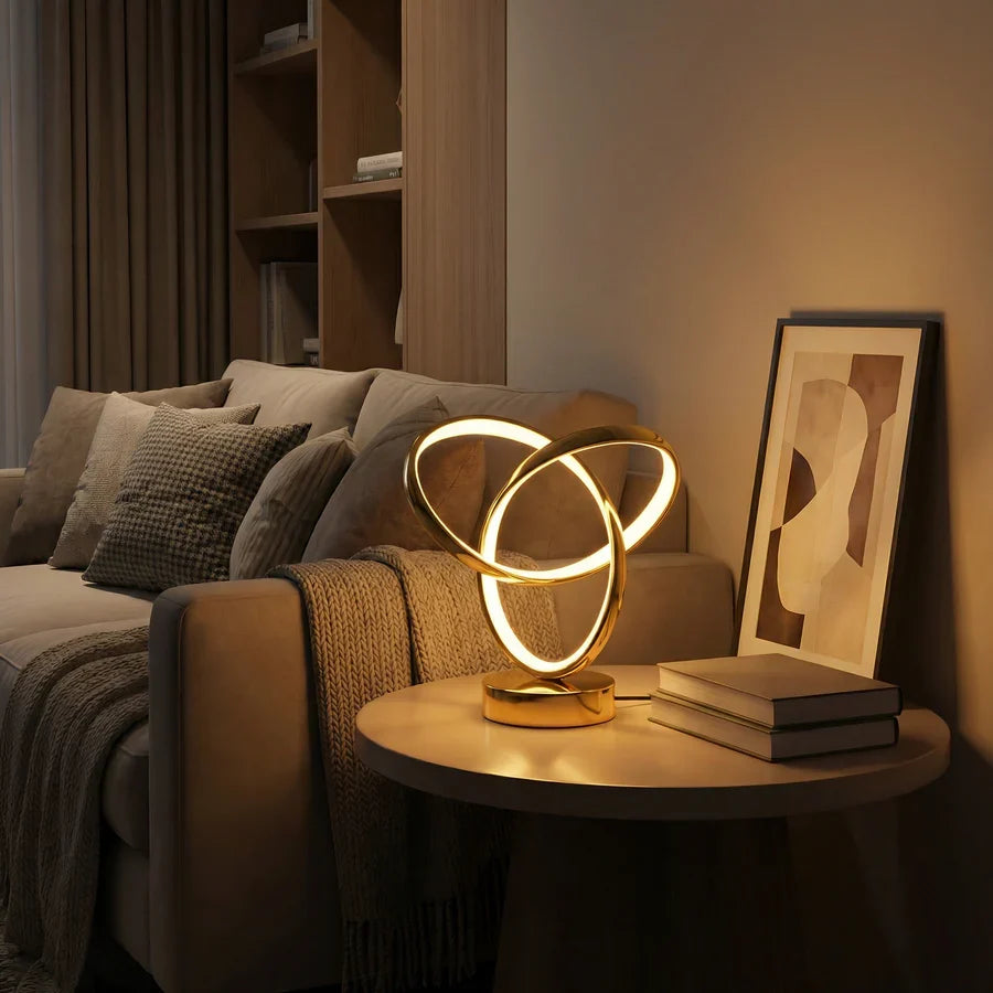 Gold LED spiral lamp on a bedside table