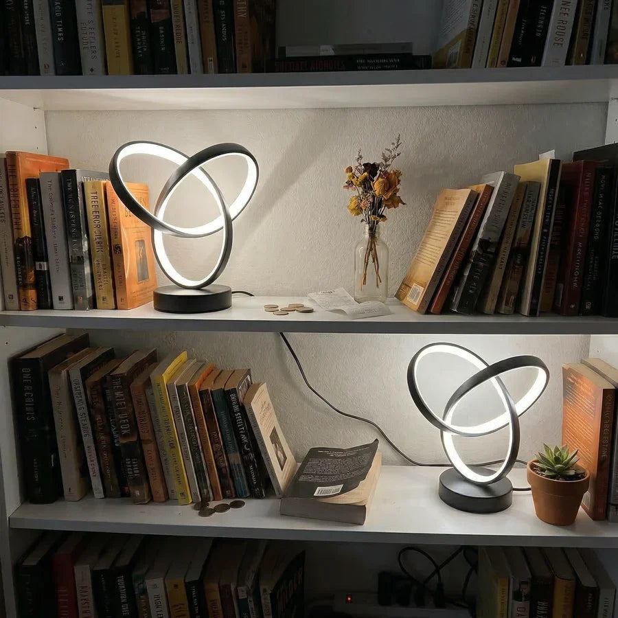 Black spiral lamps arranged on bookshelves