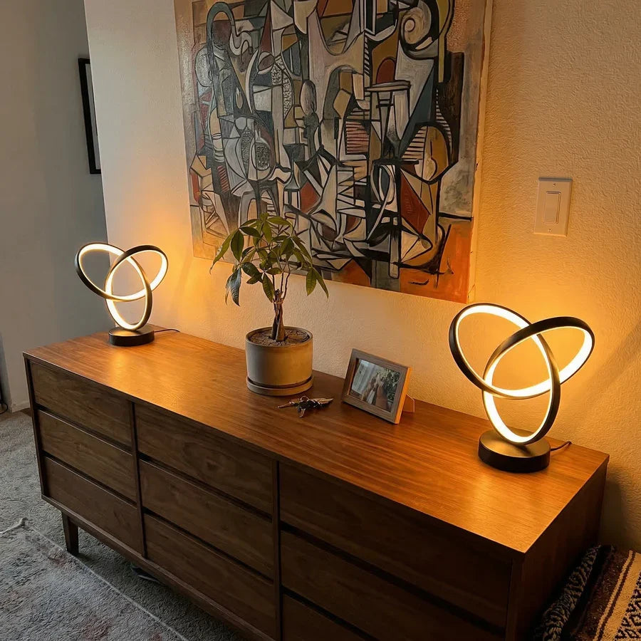 Warm illuminated spiral LED lamps on a sideboard