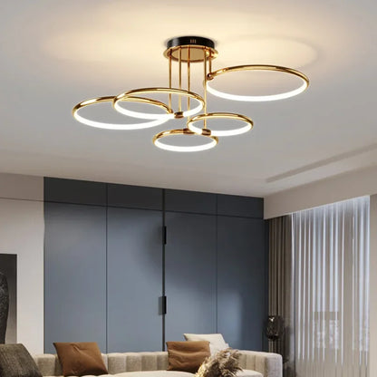 Gold multi-ring LED semi-flush ceiling light in a living room