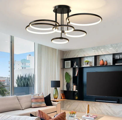Black six-ring LED ceiling light above a living room